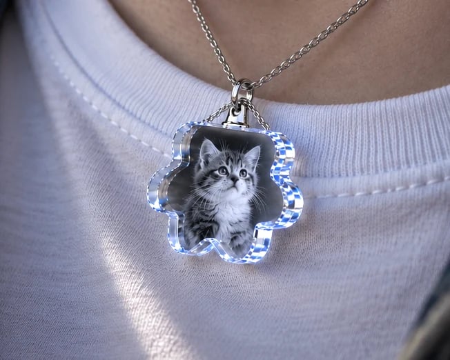 Paw crystal necklace with a kitten portrait worn over a white T-shirt